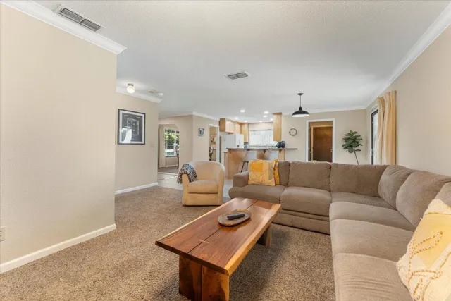 a kitchen with stainless steel appliances granite countertop a sink and a refrigerator