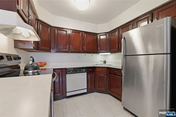 a kitchen with a refrigerator sink stove and cabinets