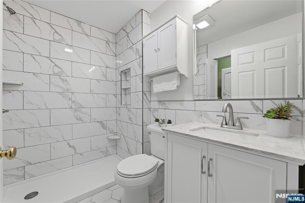 199 Union Avenue, Unit 1G Rutherford, NJ 07070 - Photo 13 of 17 a bathroom with a sink a toilet and shower