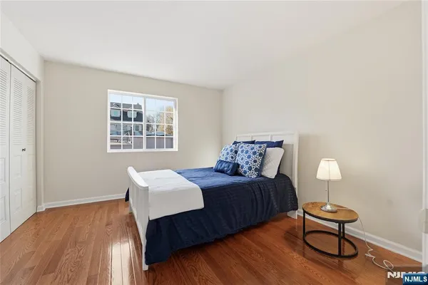 a bedroom with a bed and a lamp next to a window