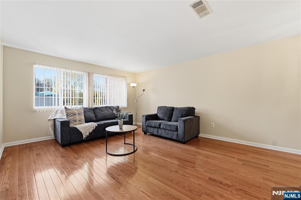 199 Union Avenue, Unit 1G Rutherford, NJ 07070 - Photo 2 of 17 a living room with furniture and a wooden floor