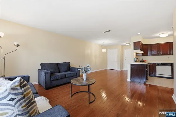 a living room with furniture and kitchen view