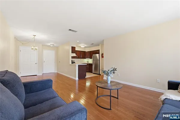 a living room with furniture and kitchen view