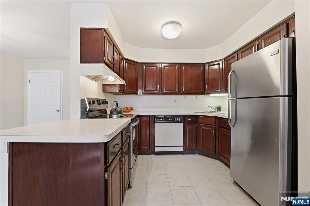 199 Union Avenue, Unit 1G Rutherford, NJ 07070 - Photo 10 of 17 a kitchen with a refrigerator a stove top oven and a sink