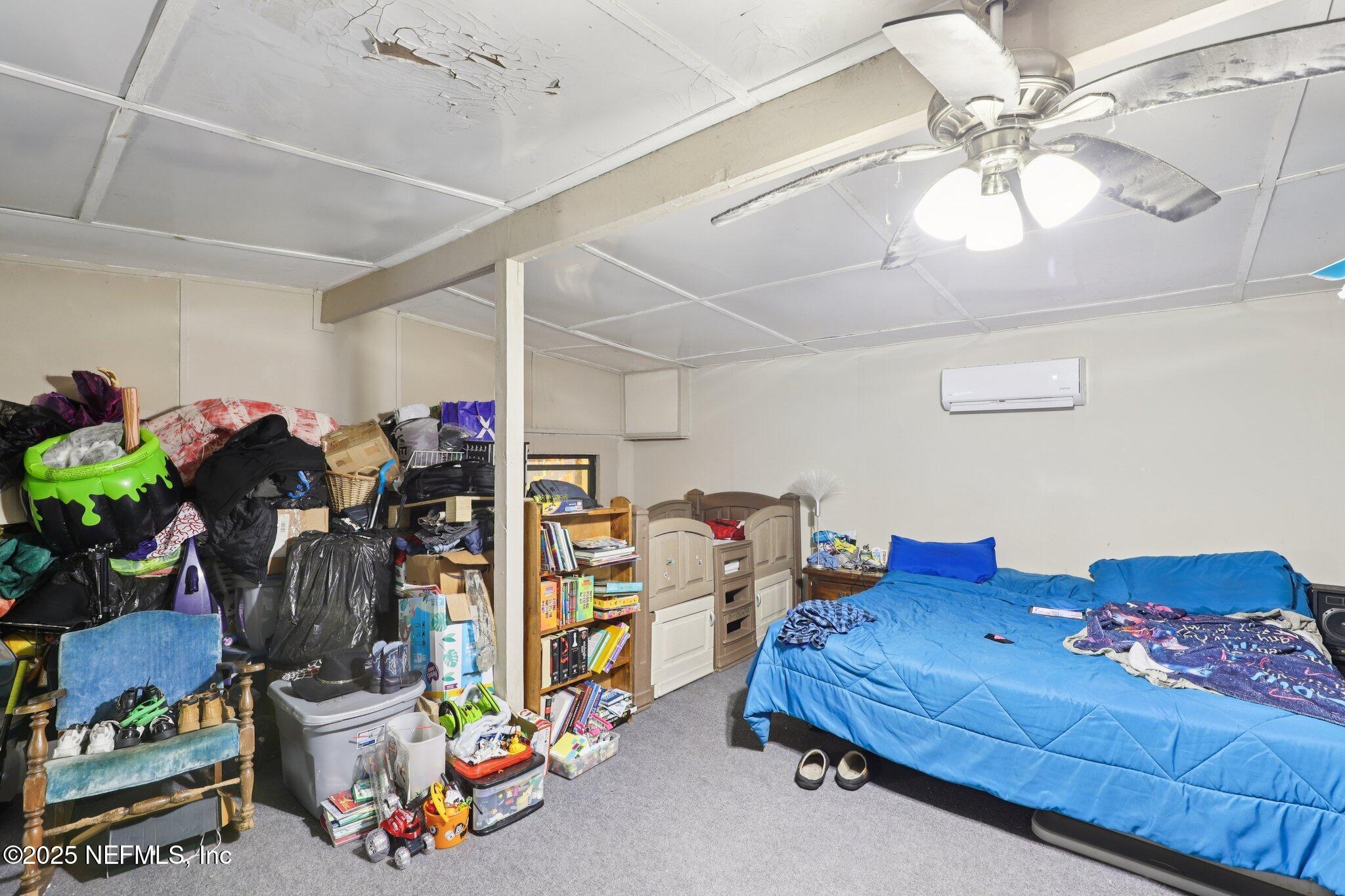 547 Southeast 58th Street Keystone Heights, FL 32656 - Photo 16 of 30 a bedroom with furniture and a chandelier