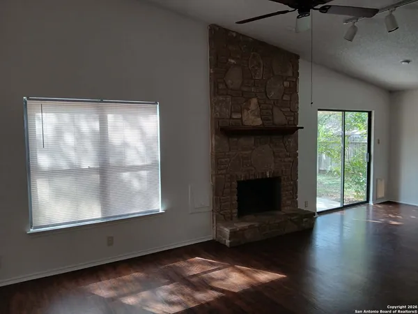 a living room with a fireplace and windows