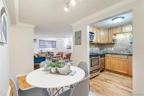 a kitchen with stainless steel appliances granite countertop a white cabinets and wooden floor