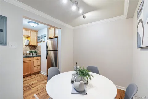 a kitchen with stainless steel appliances a refrigerator and a wooden floor