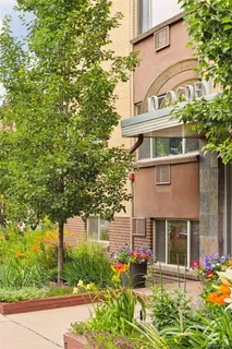 front view of a building with a garden