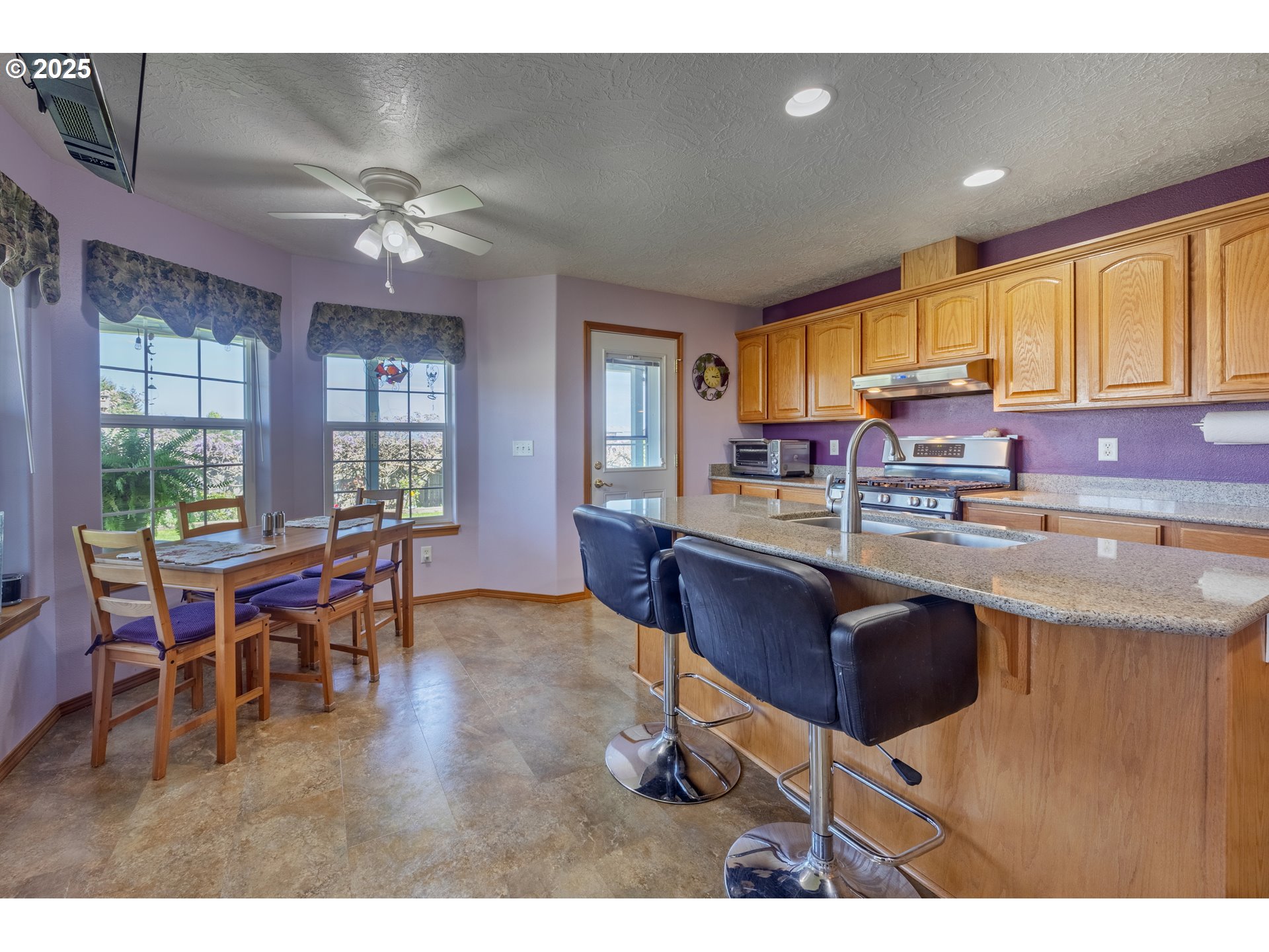 788 Southeast Meadows Loop Sheridan, OR 97378 - Photo 13 of 45 a kitchen with a dining table chairs cabinets and stainless steel appliances