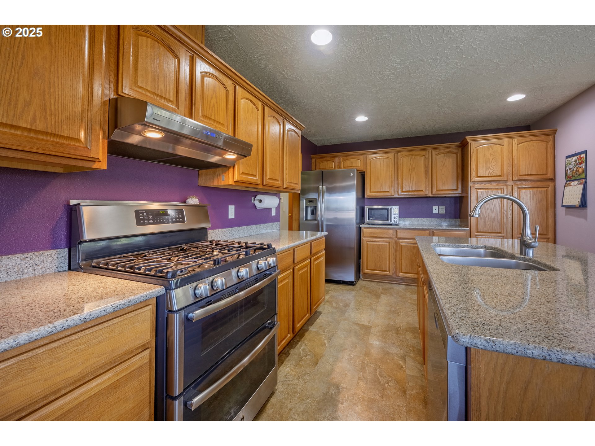 788 Southeast Meadows Loop Sheridan, OR 97378 - Photo 14 of 45 a kitchen with stainless steel appliances granite countertop a stove a sink and a microwave