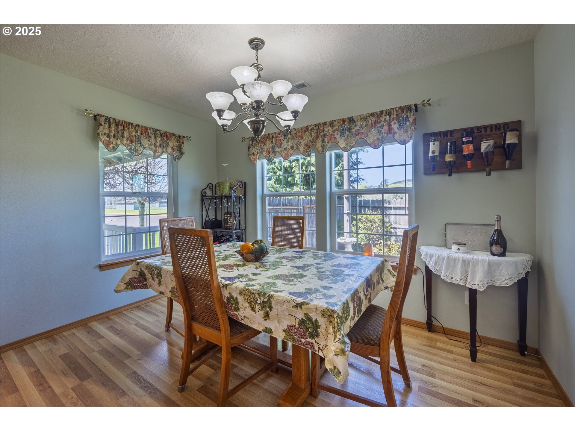 788 Southeast Meadows Loop Sheridan, OR 97378 - Photo 19 of 45 a view of a dining room with furniture a chandelier and wooden floor