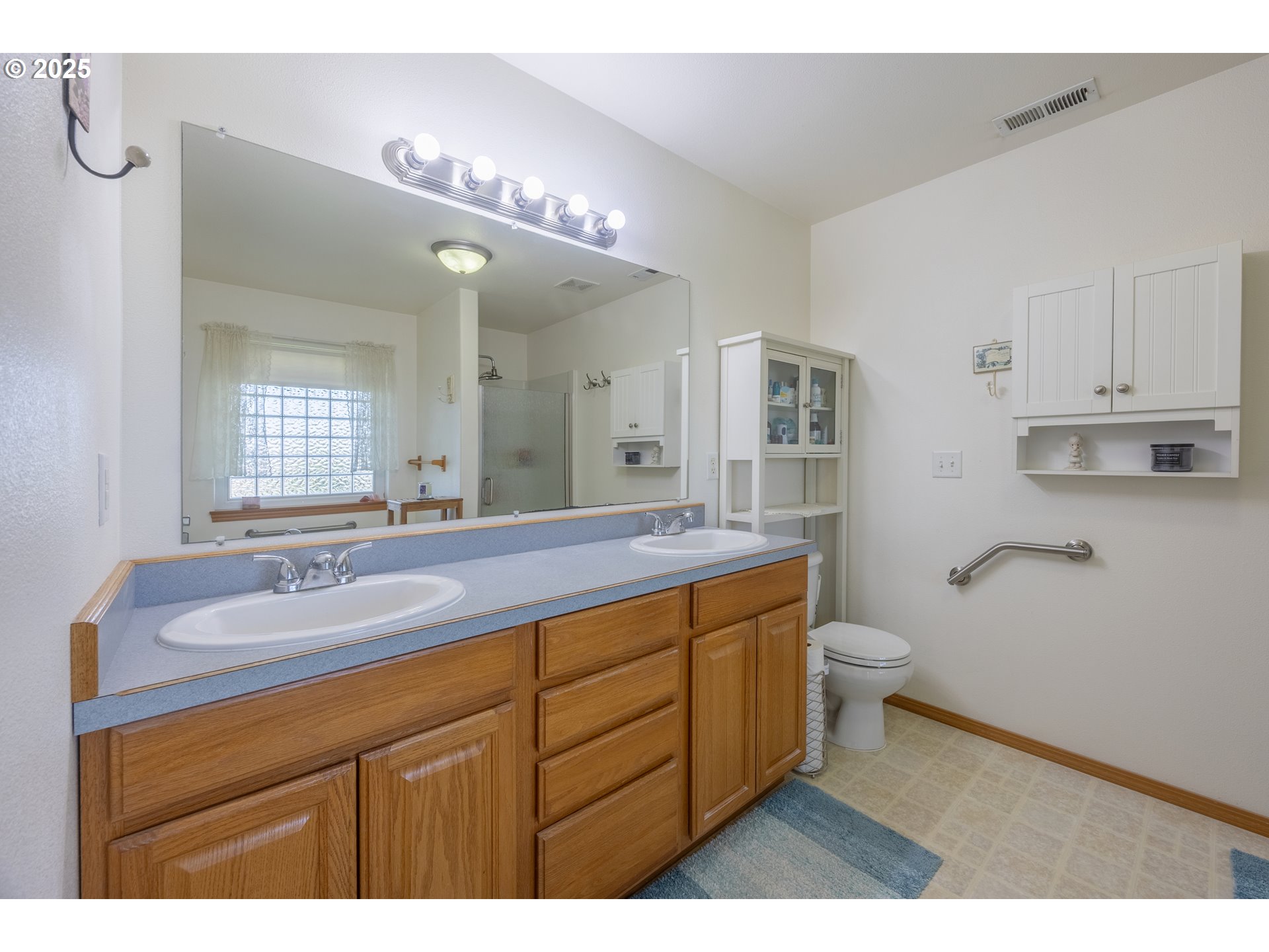 788 Southeast Meadows Loop Sheridan, OR 97378 - Photo 22 of 45 a bathroom with a granite countertop sink a toilet and a mirror