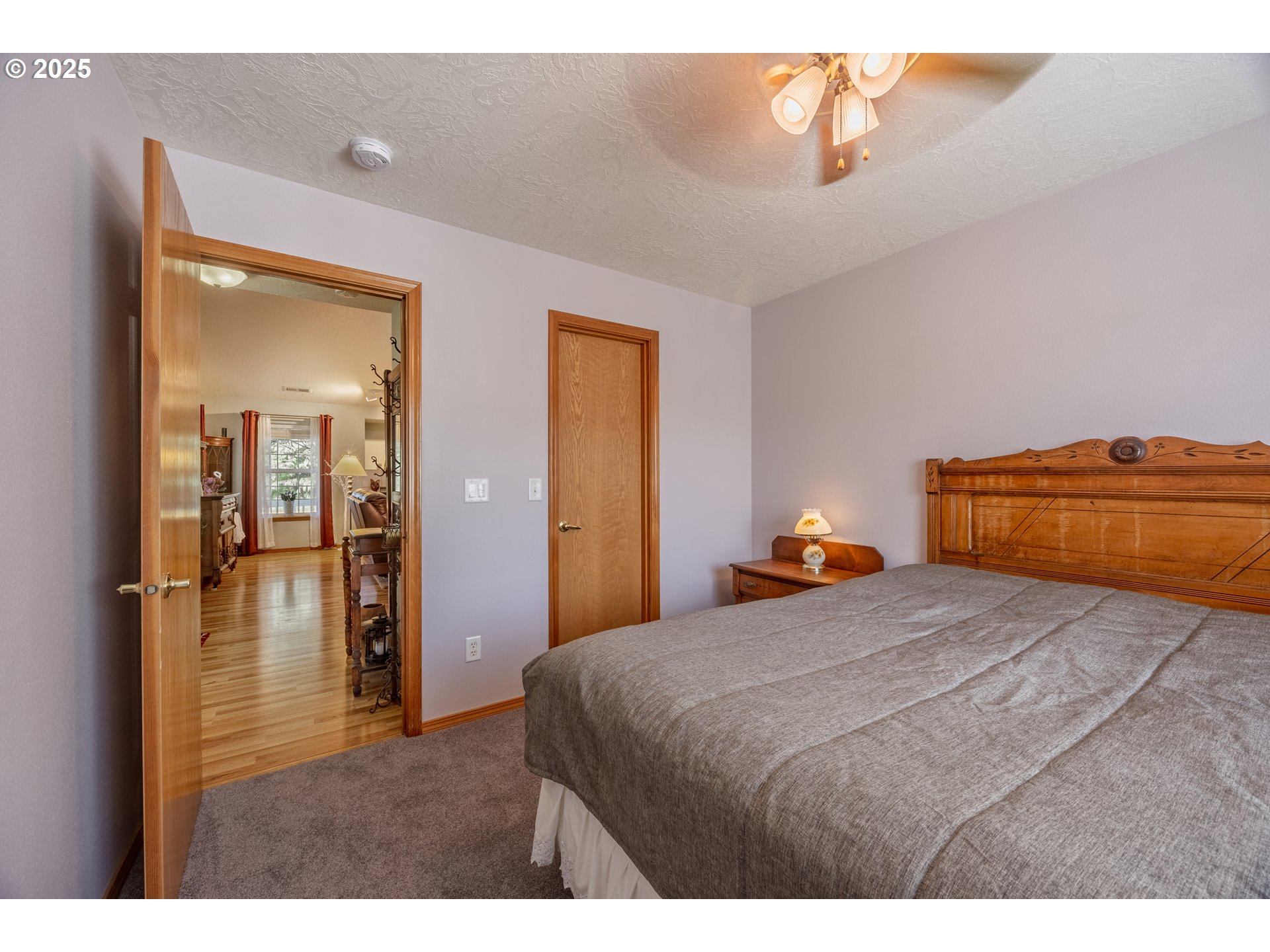 788 Southeast Meadows Loop Sheridan, OR 97378 - Photo 26 of 45 a bedroom with a bed and a chandelier