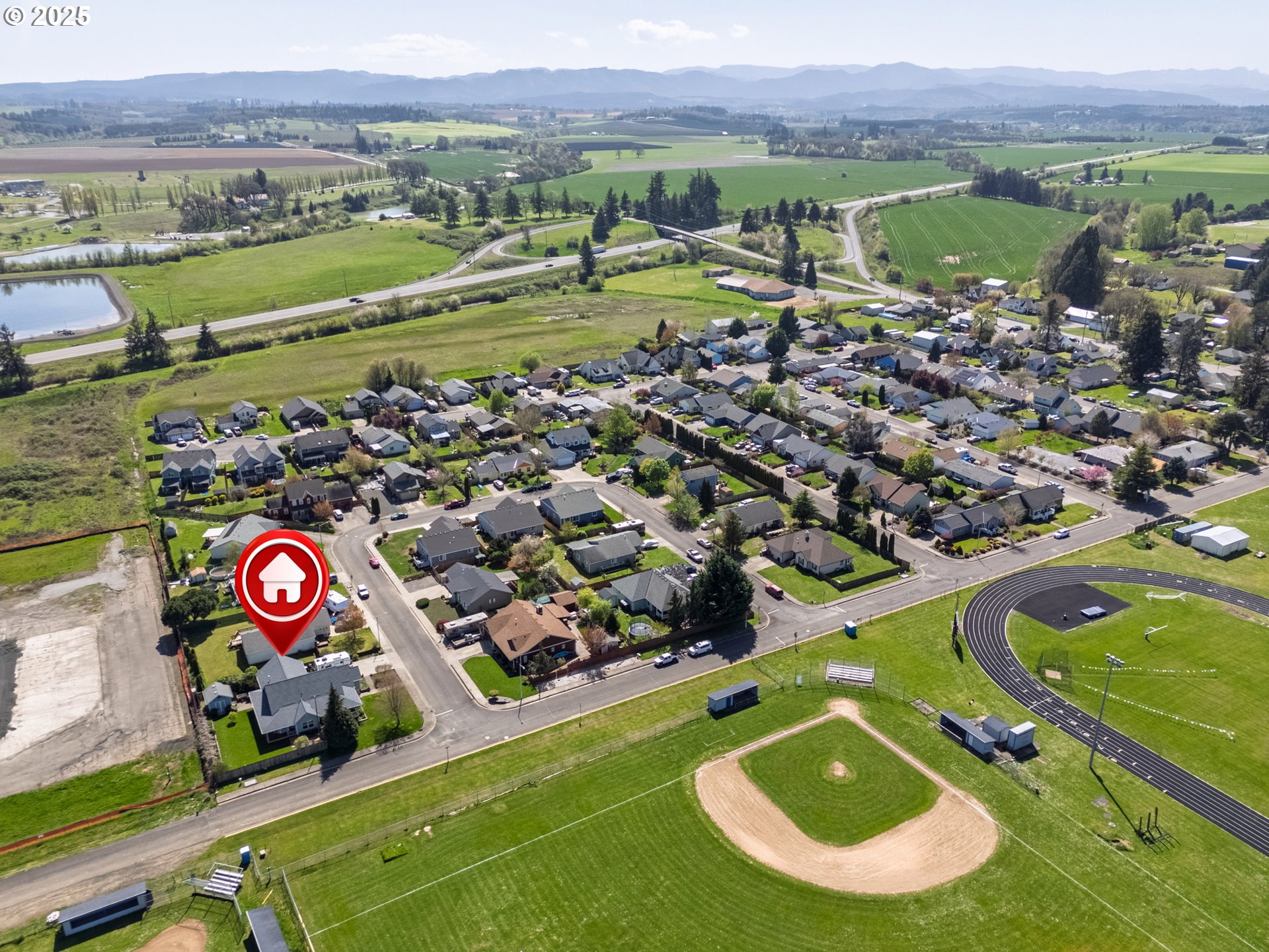 788 Southeast Meadows Loop Sheridan, OR 97378 - Photo 33 of 45 an aerial view of a house with a garden and lake view