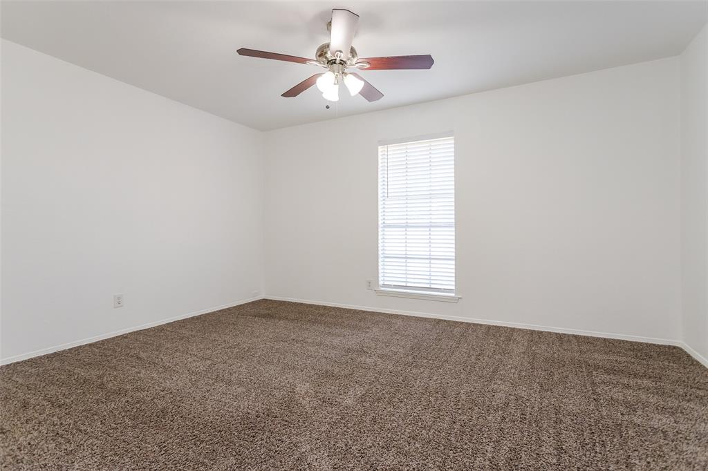 900 Milby Road Arlington, TX 76013 - Photo 15 of 28 an empty room with windows and fan