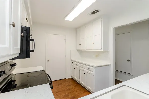 a kitchen with a sink and a stove