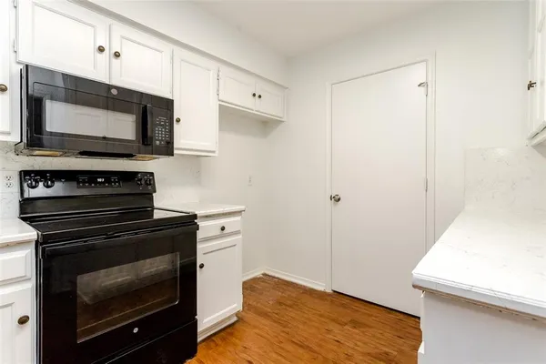 a kitchen with a stove and a microwave