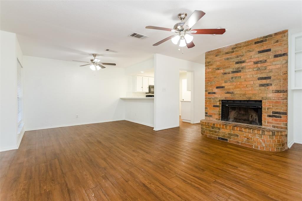 900 Milby Road Arlington, TX 76013 - Photo 7 of 28 a view of empty room with wooden floor and fireplace