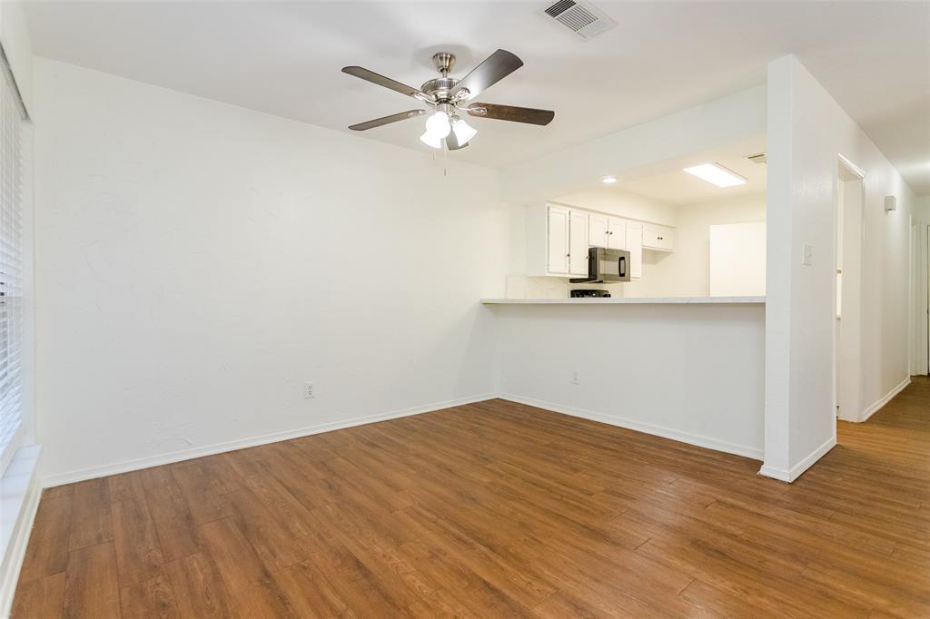 900 Milby Road Arlington, TX 76013 - Photo 8 of 28 a view of a kitchen with wooden floor and a ceiling fan