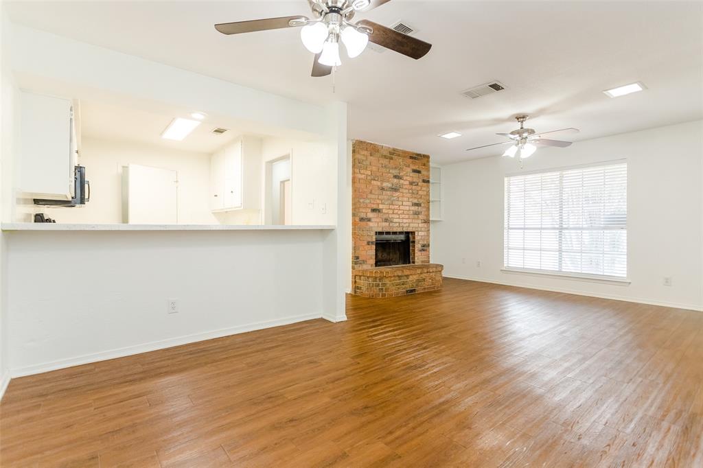 900 Milby Road Arlington, TX 76013 - Photo 10 of 28 a view of an empty room with window and wooden floor