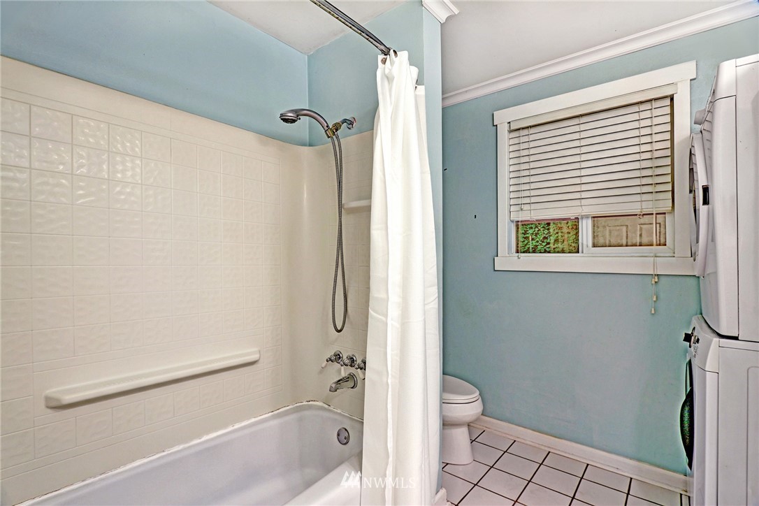 19670 Southeast 139th Place Renton, WA 98059 - Photo 12 of 25 a bathroom with a granite countertop window a toilet and a shower