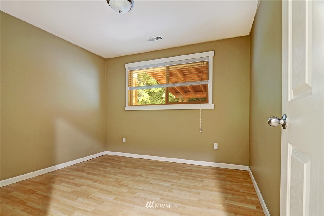 19670 Southeast 139th Place Renton, WA 98059 - Photo 14 of 25 a view of an empty room with wooden floor and a window