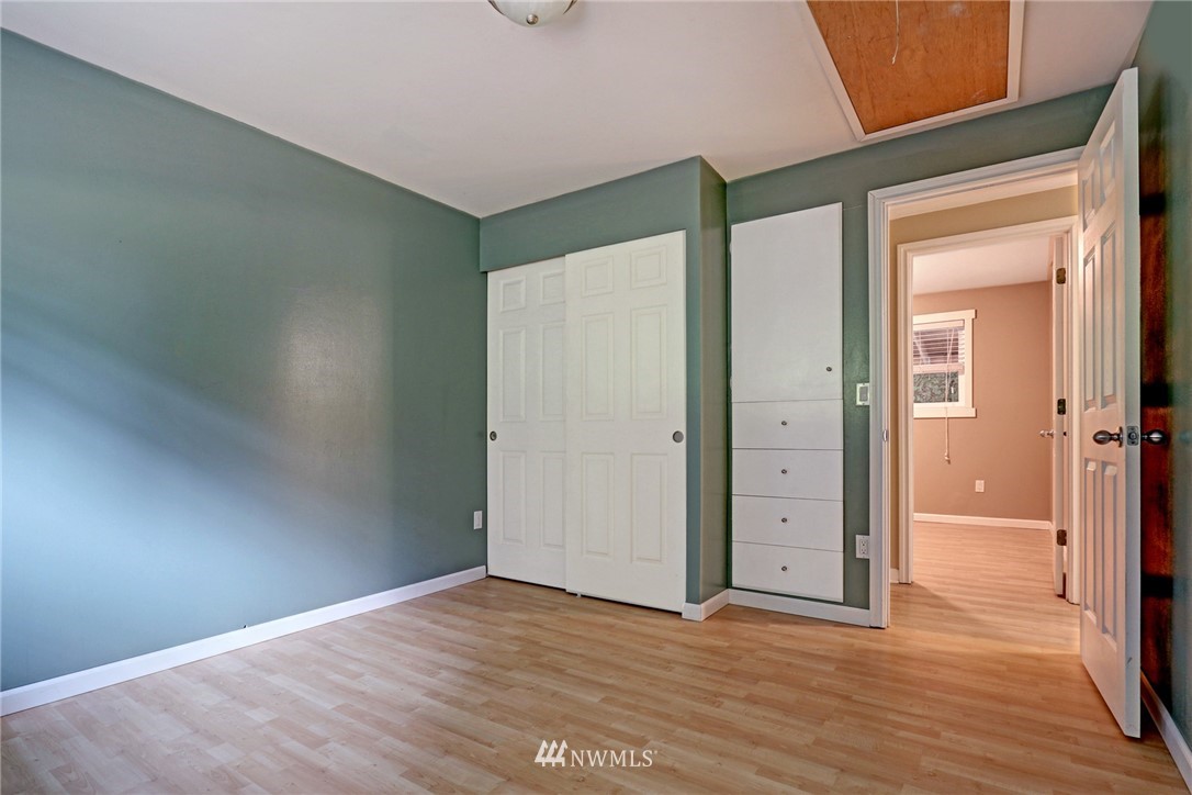 19670 Southeast 139th Place Renton, WA 98059 - Photo 18 of 25 an empty room with wooden floor and windows
