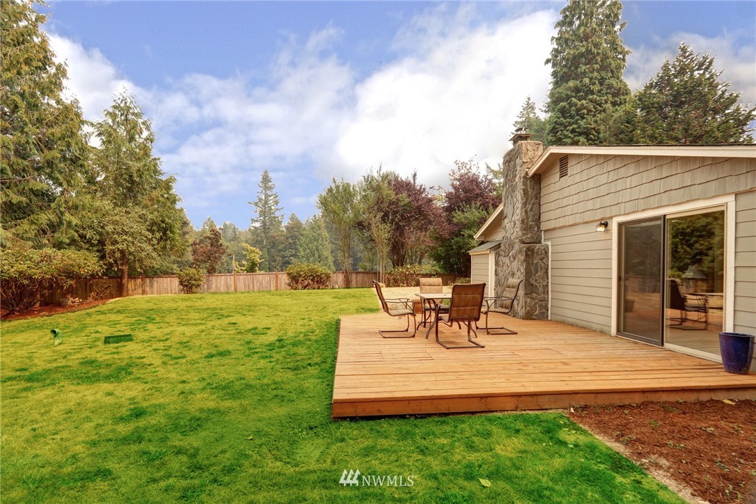 19670 Southeast 139th Place Renton, WA 98059 - Photo 22 of 25 a view of a bench in the garden near a lake
