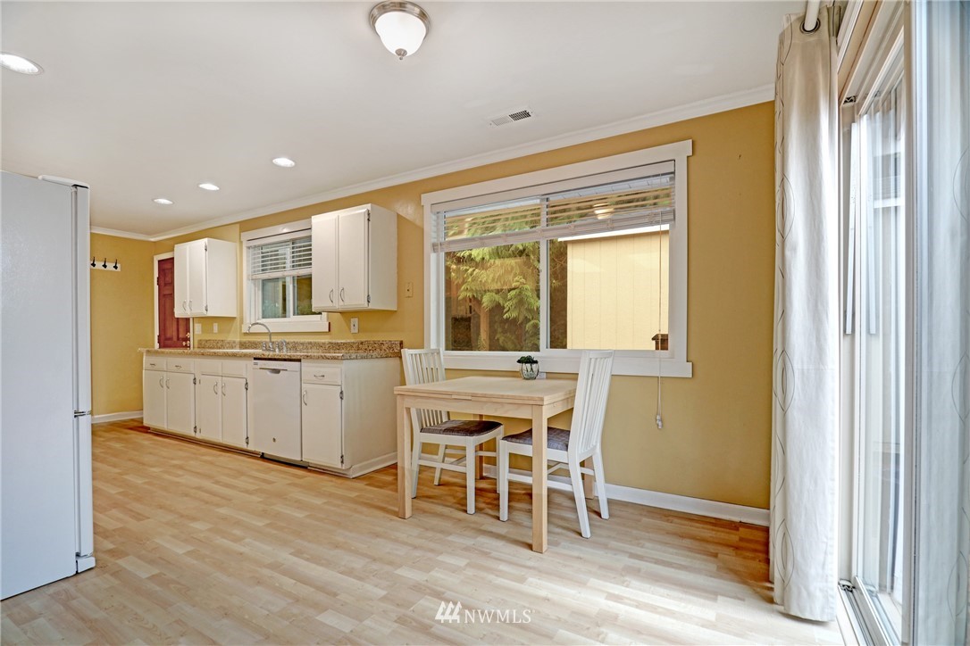 19670 Southeast 139th Place Renton, WA 98059 - Photo 8 of 25 a kitchen with a window and chairs