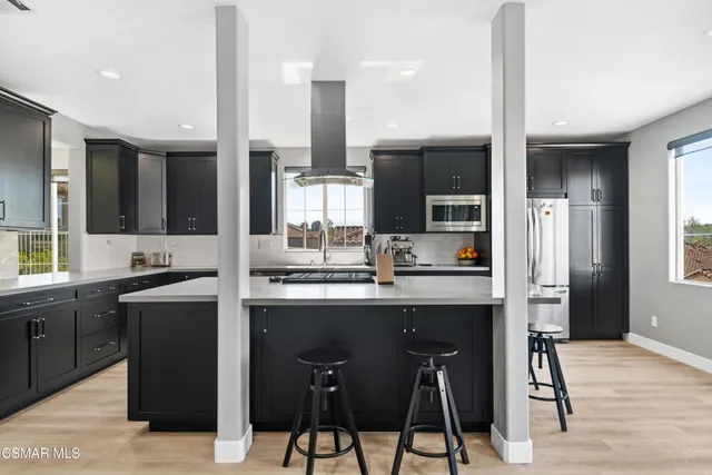 a kitchen with cabinets a sink oven and refrigerator