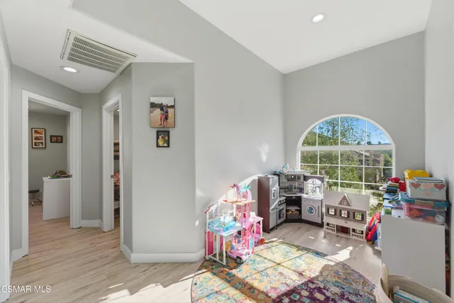a living room with furniture a window and gym equipment