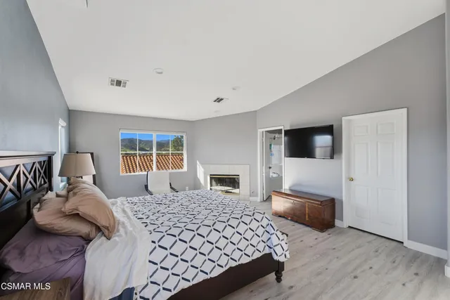 a bedroom with a large bed and a couch