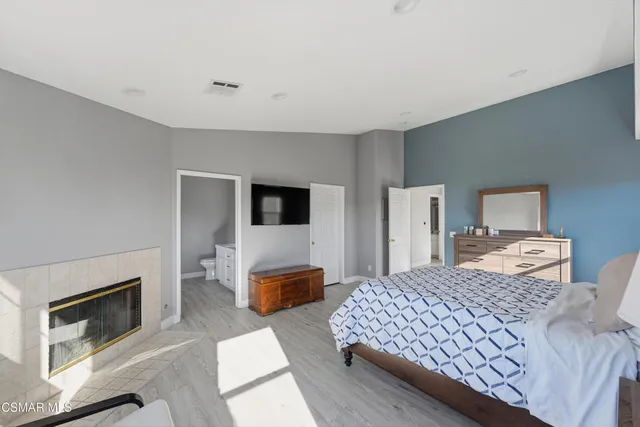 a bedroom with a large bed and a couch