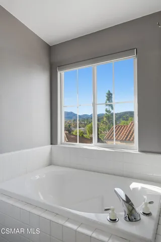 a bathroom with a bathtub and window