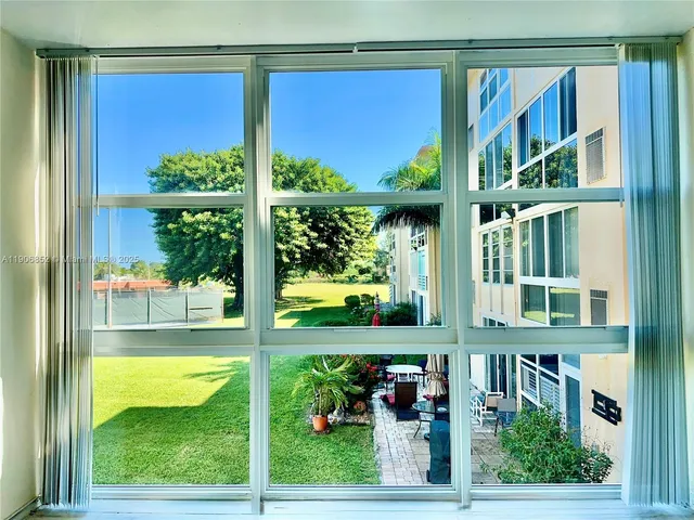 a view of a porch with a floor to ceiling window and an outdoor space