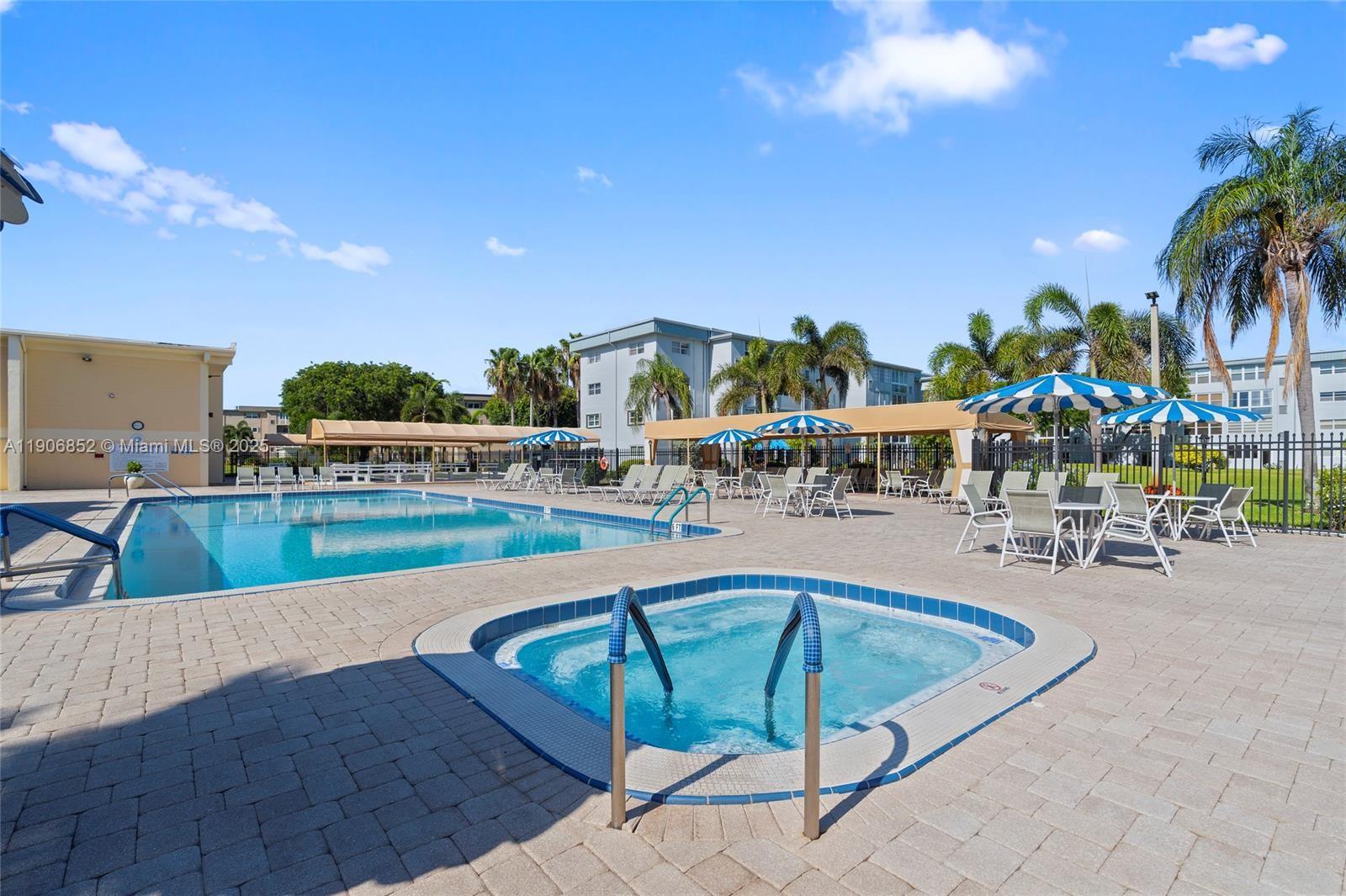 2520 Northeast 1st Court, Unit 204 Boynton Beach, FL 33435 - Photo 15 of 23 a view of a swimming pool with outdoor seating