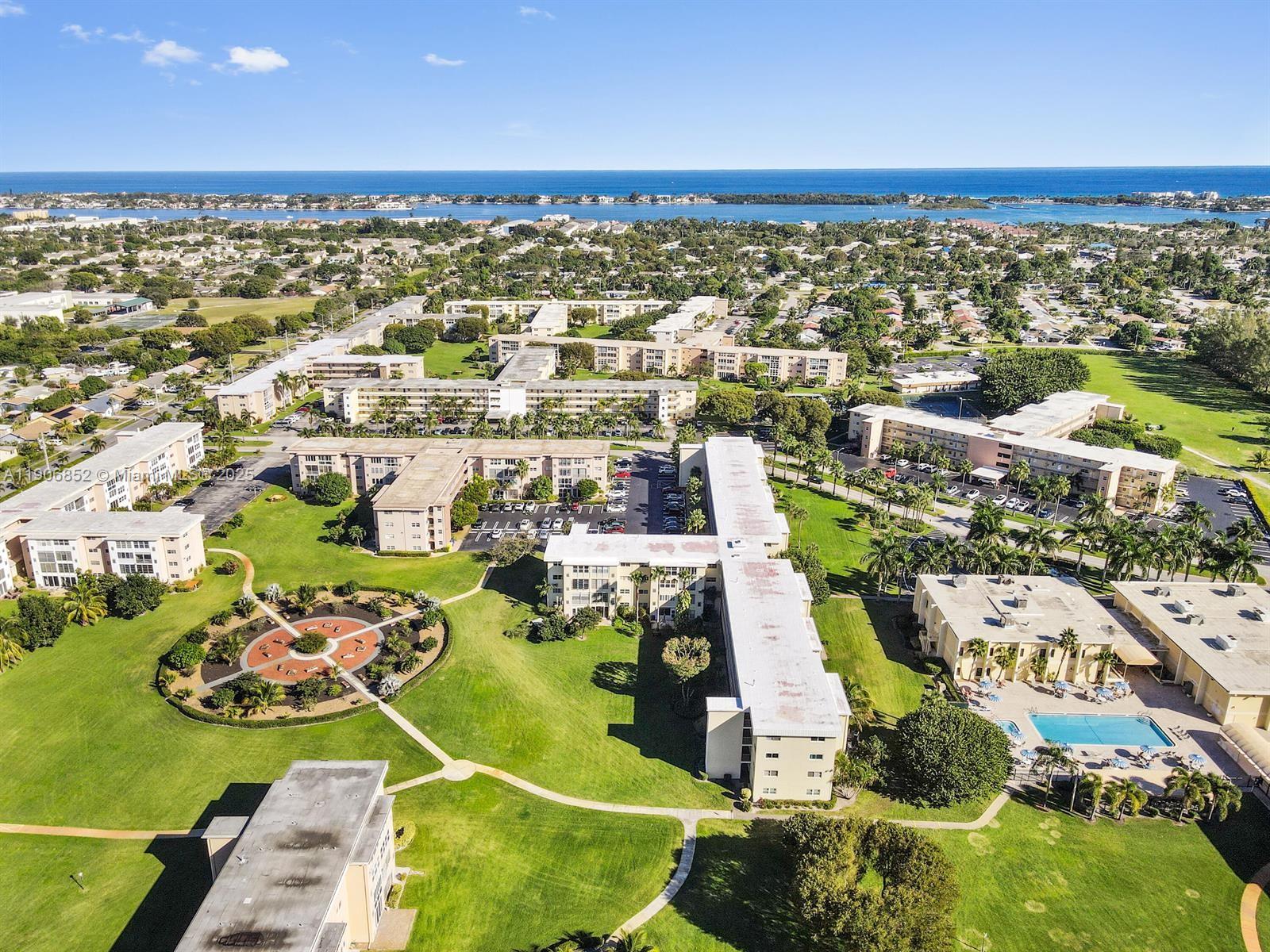 2520 Northeast 1st Court, Unit 204 Boynton Beach, FL 33435 - Photo 23 of 23 an aerial view of a city with lots of residential buildings ocean and mountain view in back