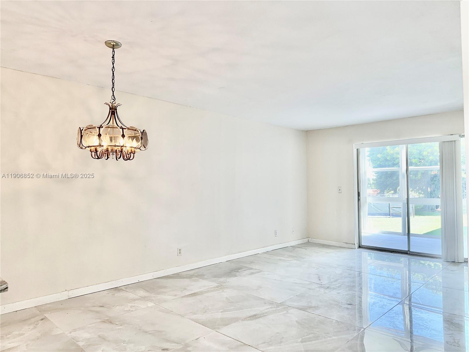2520 Northeast 1st Court, Unit 204 Boynton Beach, FL 33435 - Photo 5 of 23 a view of a room with cabinet and a window