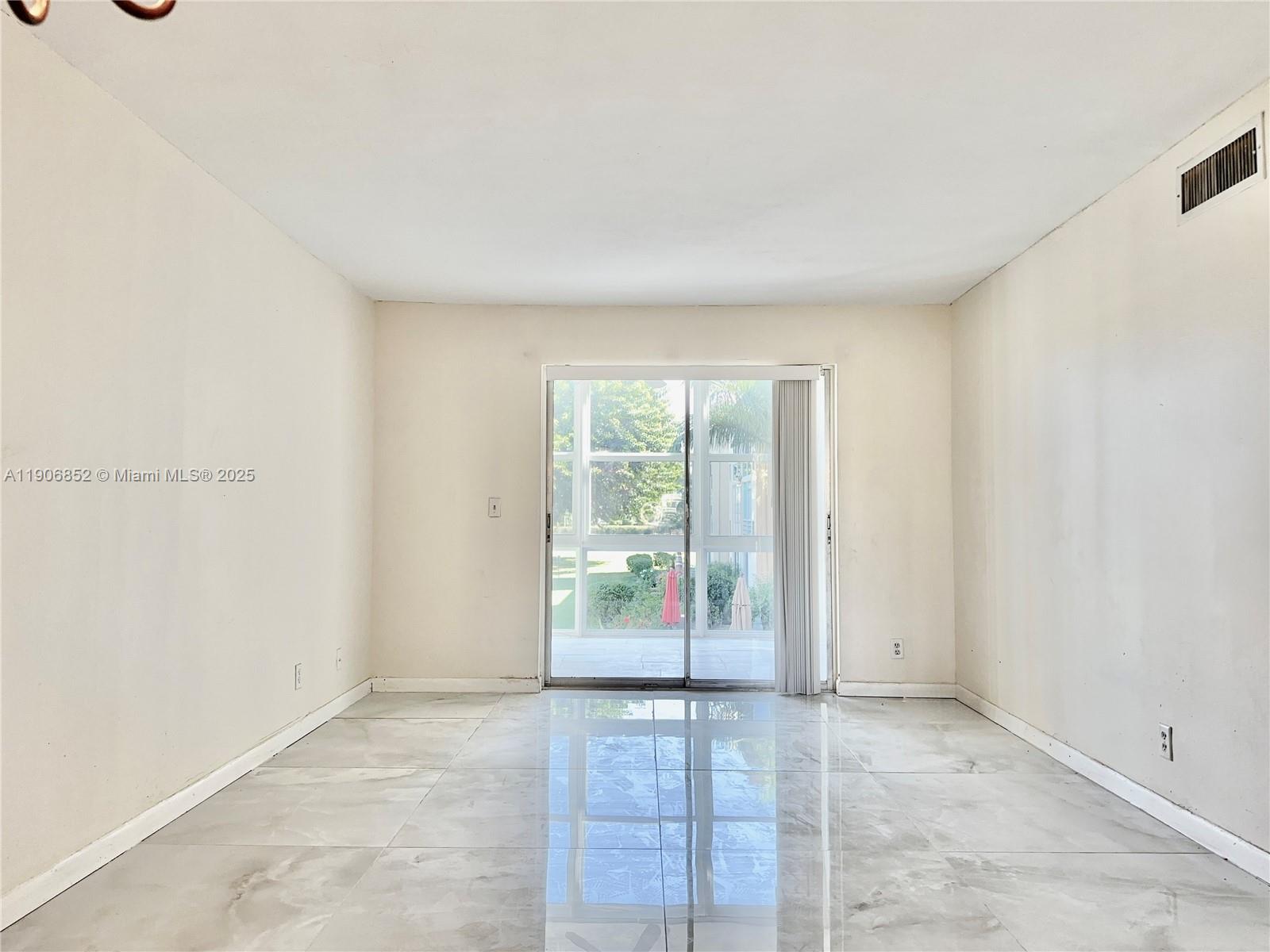 2520 Northeast 1st Court, Unit 204 Boynton Beach, FL 33435 - Photo 6 of 23 an empty room with window