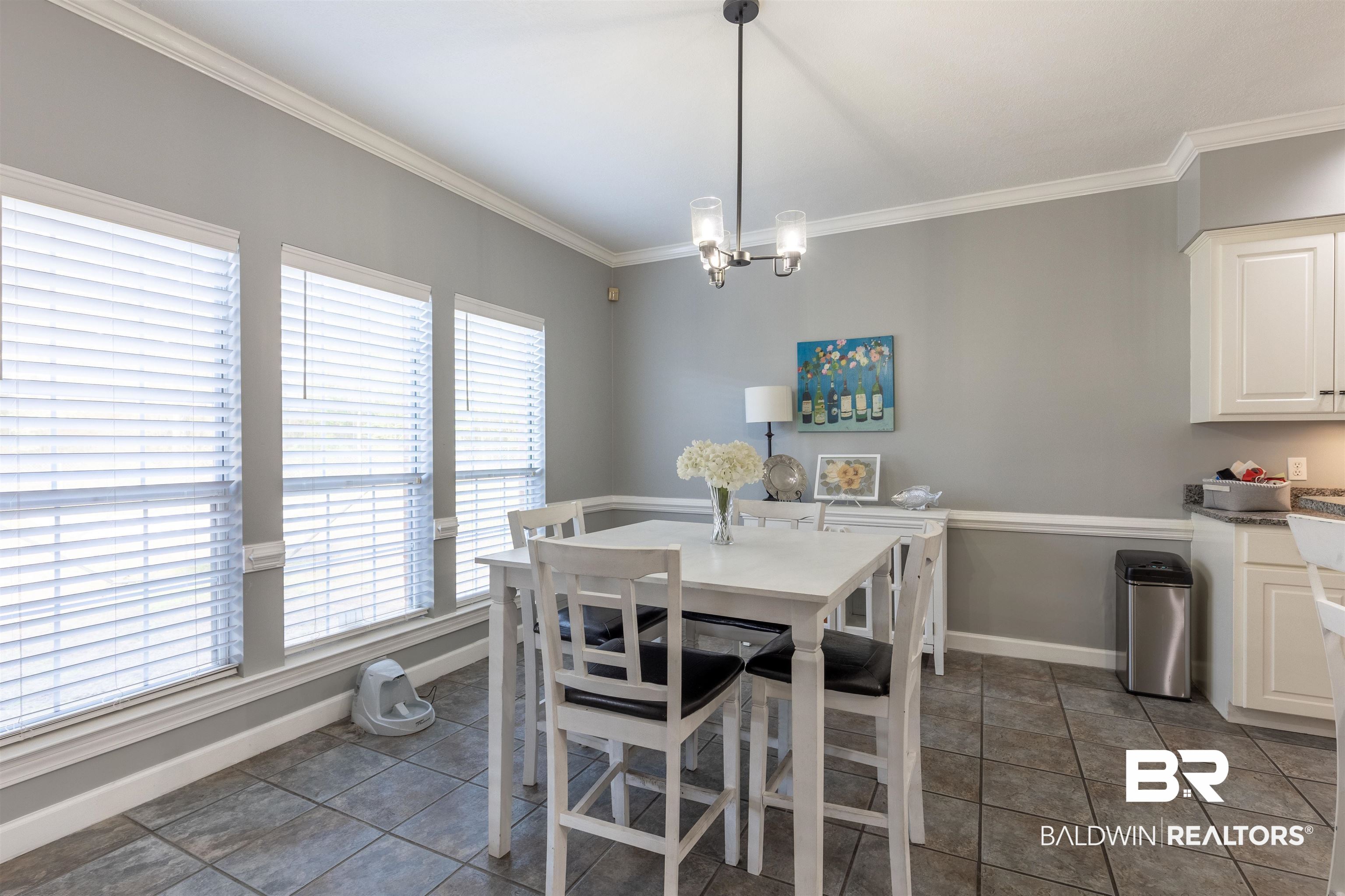 6436 Cherry Ridge Court West Mobile, AL 36695 - Photo 15 of 26 Dining area with a notable chandelier, crown molding, baseboards, and dark tile patterned floors