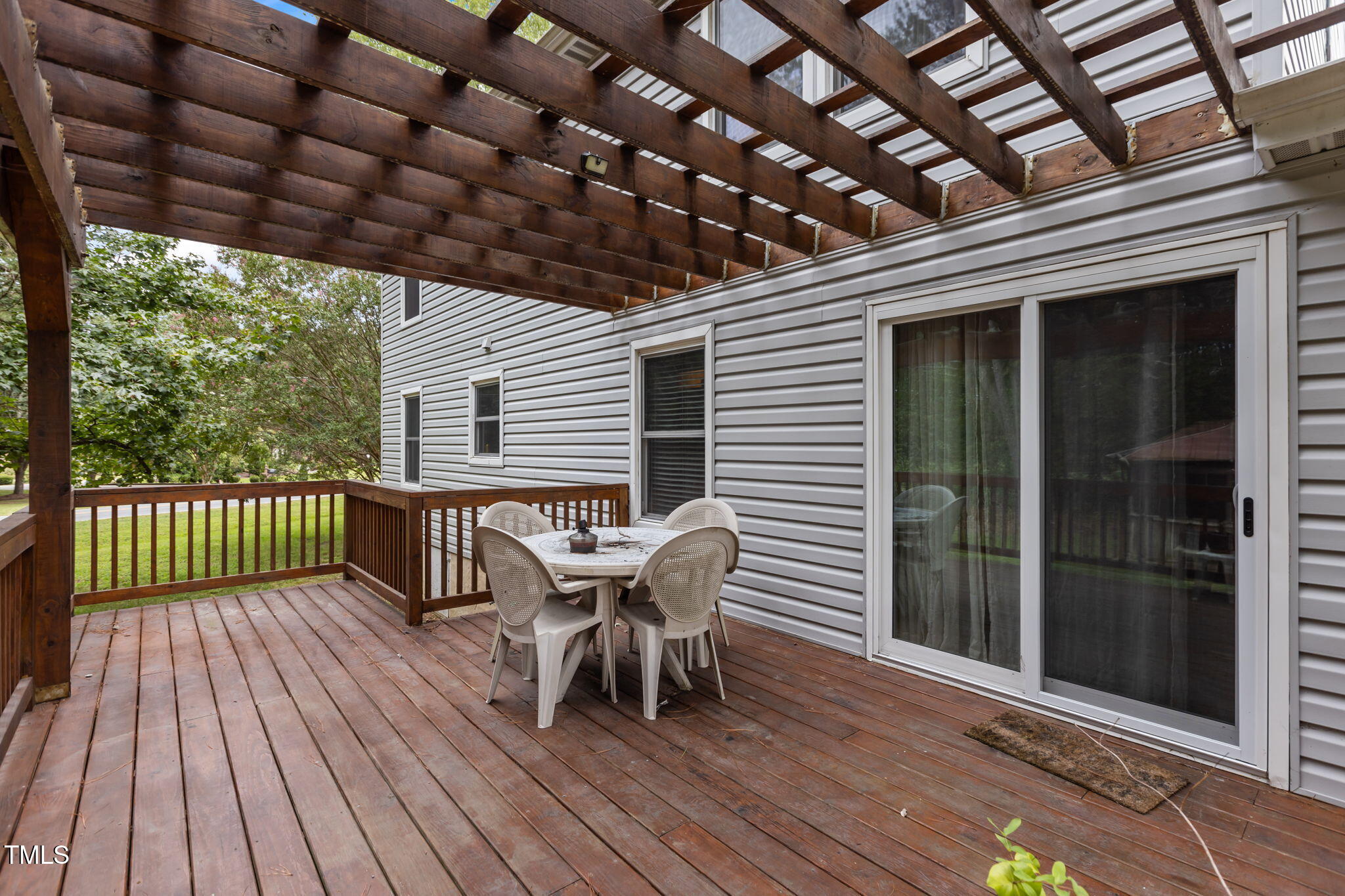 402 Carpenter Fletcher Road Durham, NC 27713 - Photo 3 of 42 a patio with wooden floor a yard a table and chairs