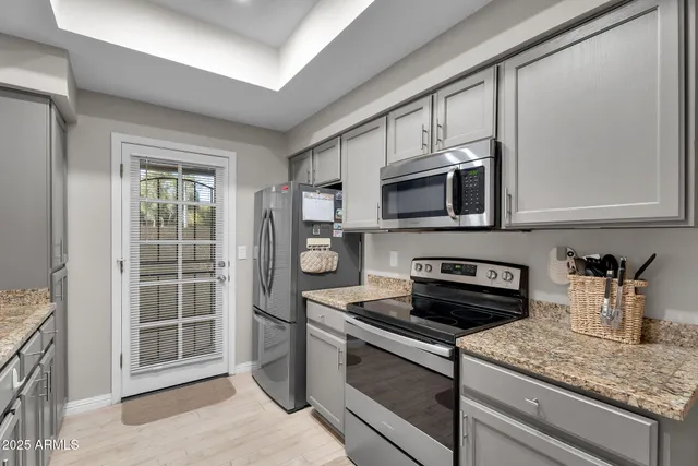 a kitchen with stainless steel appliances granite countertop a sink and a cabinets