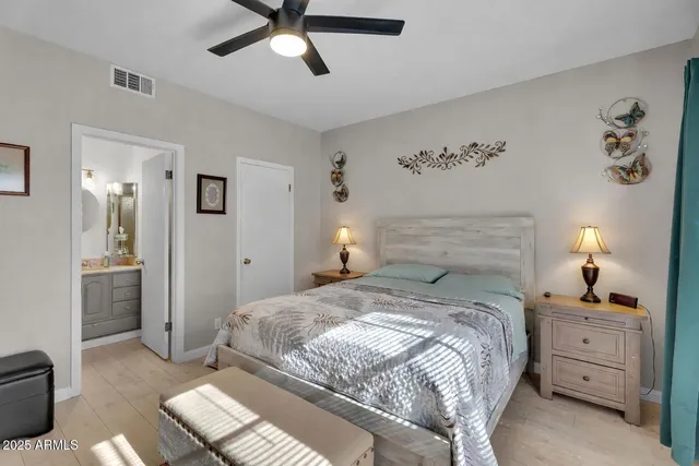 a bedroom with a bed and a large window