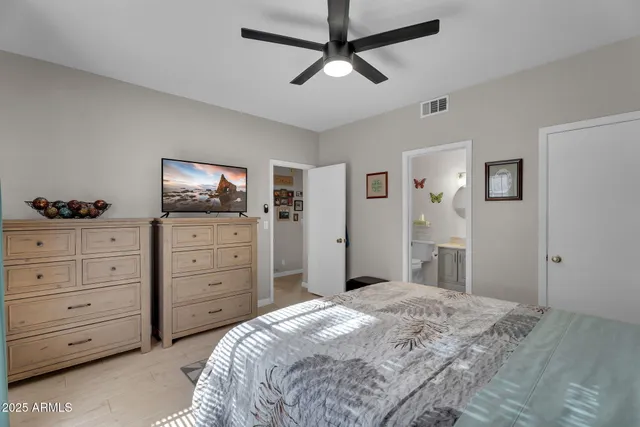 a bedroom with a bed and a chandelier