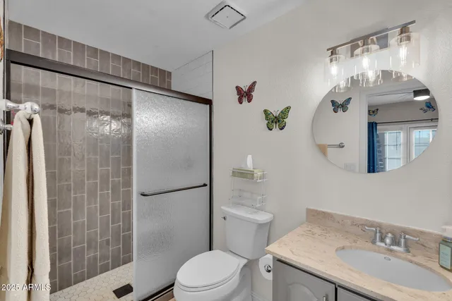 a spacious bedroom with a bed and a flat screen tv