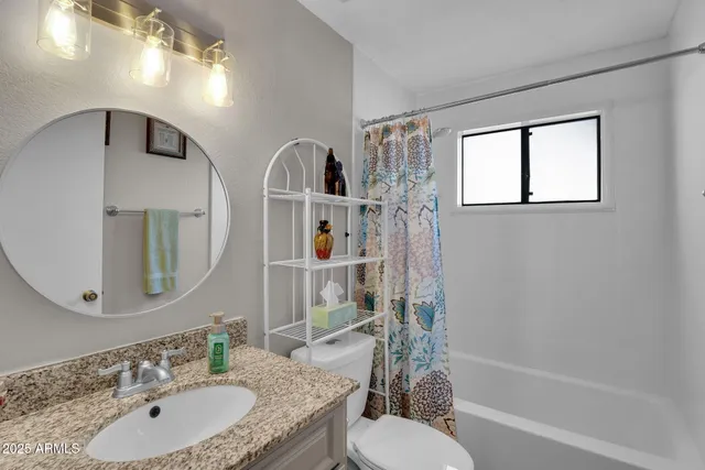 a view of a livingroom with wooden floor and windows