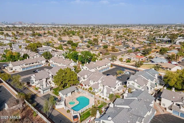 an aerial view of a house with a swimming pool