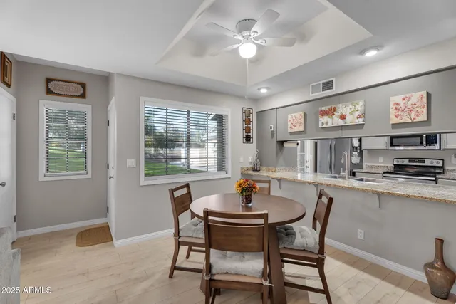 a kitchen with stainless steel appliances granite countertop a sink stove and cabinets