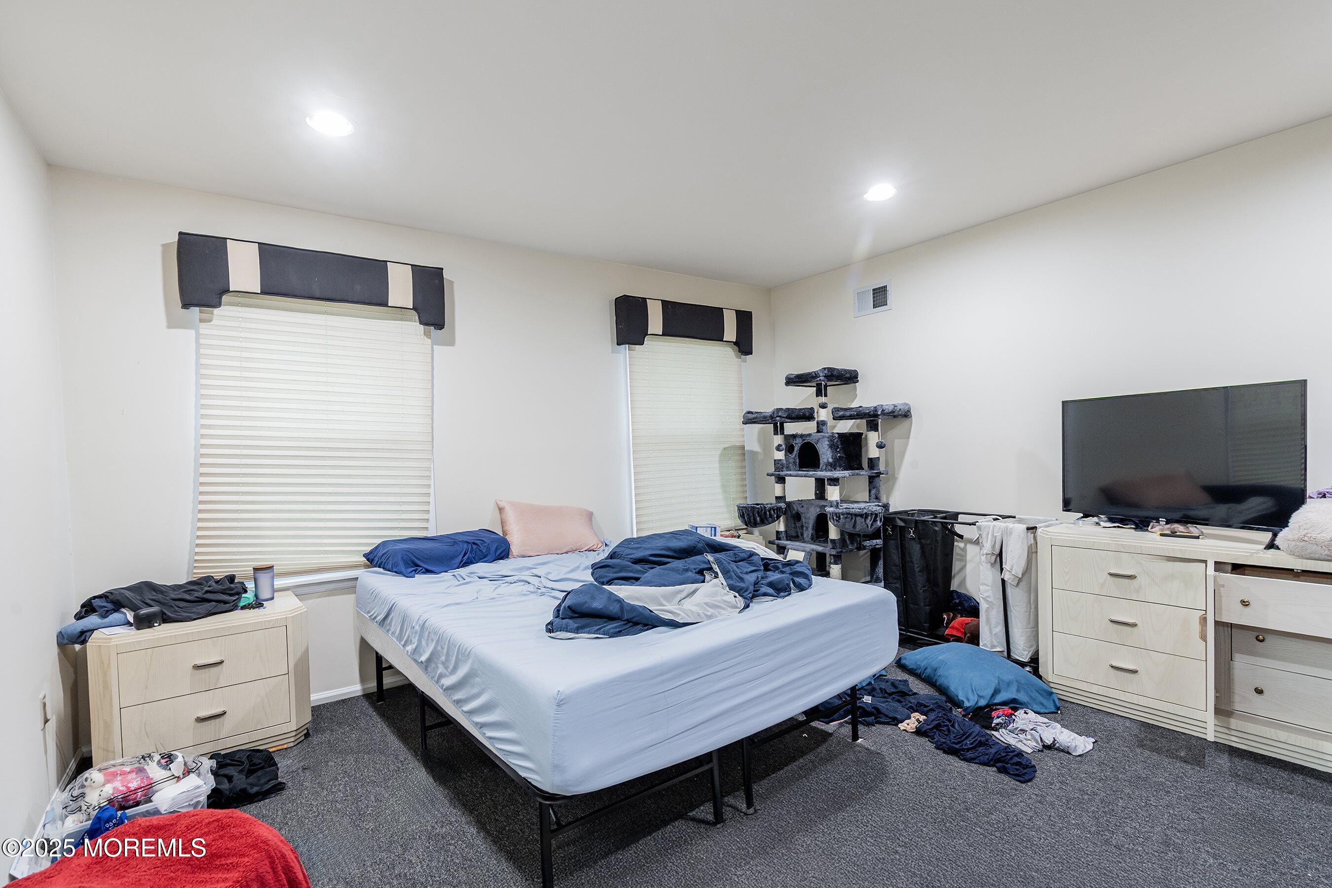 47 Sweet Gum Road Howell, NJ 07731 - Photo 18 of 27 a living room with furniture and a flat screen tv